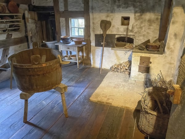 View into historical kitchen left old washing tub wooden tub back recessed in wall oven for baking bread for baking bread in old rebuilt restored small farmhouse weaver's house half-timbered house in open-air museum Neuhausen, Neuhausen ob Eck, district of Tuttlingen, Baden-Württemberg, Germany, Europe