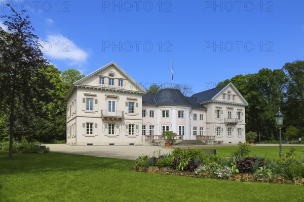 Villa Eugenia, last residence of the Princes of Hohenzollern-Hechingen, classicist central building built from 1786 to 1787 by Prince Joseph Wilhelm as a summer pleasure garden house, side wings added from 1833 to 1834, residence for the then hereditary prince and later princely couple Friedrich Wilhelm Konstantin and Eugenie, meadow, park, garden, historic building, architecture, clouds, sky, flagpole, Hohenzollern coat of arms, Hechingen, Zollernalbkreis, Baden-Württemberg, Germany, Europe