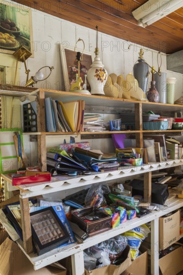 Paintings, lamps and stationary items for sale inside second hand goods and chattels store, Quebec, Canada, North America