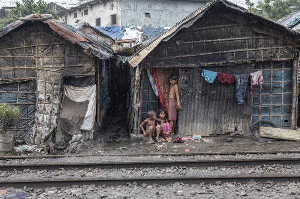 Children in front of their house, which was built right next to the railway tracks, Tejgaon Slum Area, Dhaka, Bangladesh, Asia