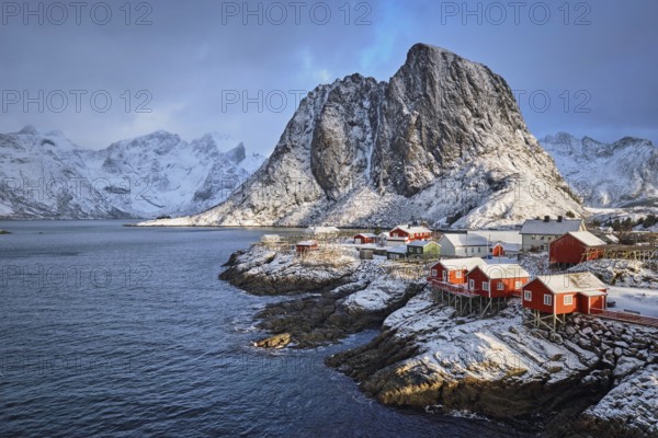 Famous tourist attraction Hamnoy fishing village on Lofoten Islands, Norway with red rorbu houses in winter