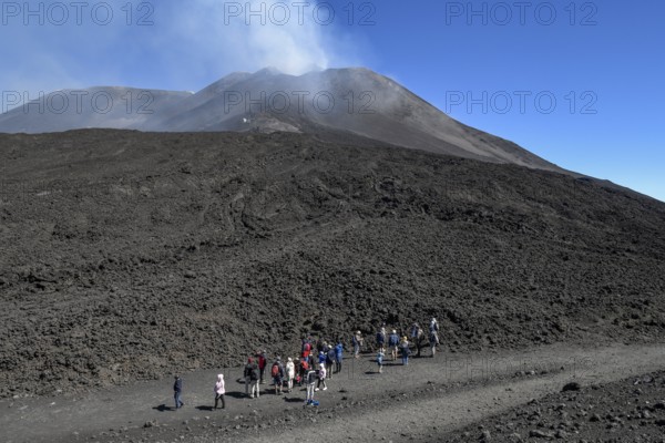 Hikers in the crater landscape of the volcano Etna, summit region, province of Catania, Sicily, Italy, Europe