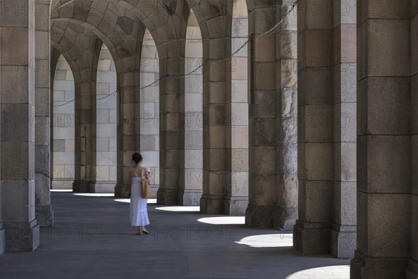 Lady in a white dress in the arcade of the Congress Hall, unfinished National Socialist monumental building on the Nazi Party Rally Grounds, Nuremberg, Middle Franconia, Bavaria, Germany, Europe