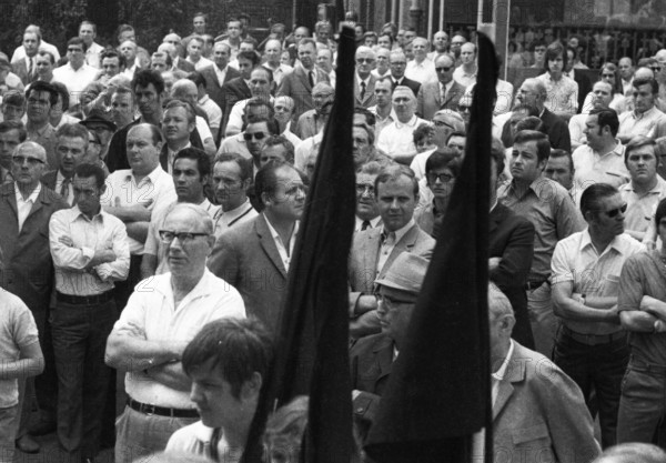 With black flags, mourning and anger, workers of Delog, a factory for flat glass, demonstrated in Gelsenkirchen on 13 July 1971 for the preservation of their jobs