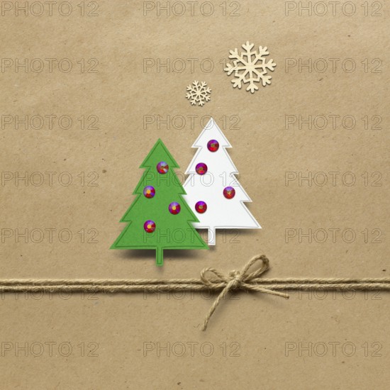 Creative concept photo of paper Christmas trees on a brown background