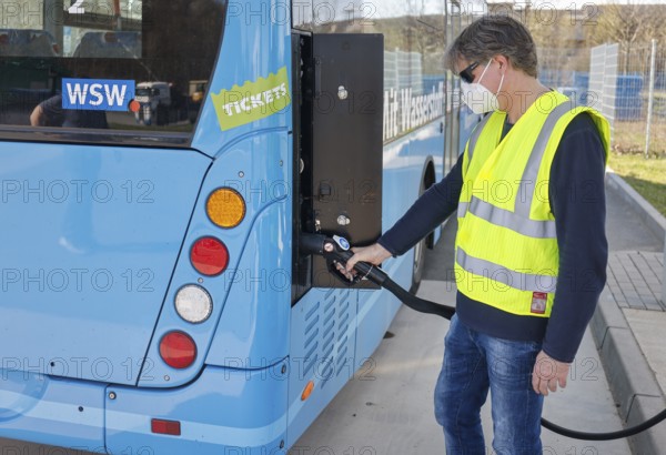 Herten, North Rhine-Westphalia, Germany - Wuppertal hydrogen bus fills up with H2 hydrogen at an H2 hydrogen filling station, press event Test refuelling at the H2 filling station at the h2herten user centre, Herten hydrogen competence centre on the site of the disused Ewald mine in Herten, the 350-bar refuelling unit supplies cooled hydrogen and is currently the most powerful refuelling facility in Germany