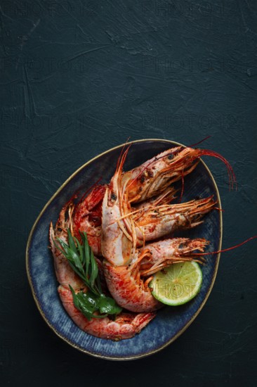 Langoustines, Australian, freshly frozen on ice, top view, lime and greens