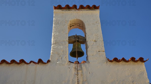 Close-up of a bell tower with a bell under a blue sky, Agios Ioannis church, Mesochori village, west coast, Karpathos, Dodecanese, Greek Islands, Greece, Europe