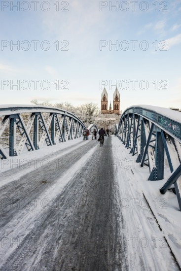 Bridge with snow and ice and cyclists, Blue Bridge and Stühlinger Church, Freiburg im Breisgau, Black Forest, Baden-Württemberg, Germany, Europe