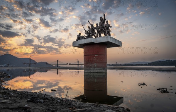 Guwahati, India. 25 November 2024. Statue of Ahom commander Lachit Barphukan and soldiers stands in the Brahmaputra river, made by master sculptor Biren Singha in 2016, in Guwahati