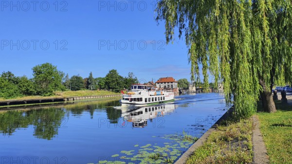 A peaceful river landscape with a boat and overhanging trees, Birkut ship, Elblag River, Elblag, Elbing, Warminsko-Mazurskie Voivodeship, Warminsko-Mazurskie, Poland, Europe