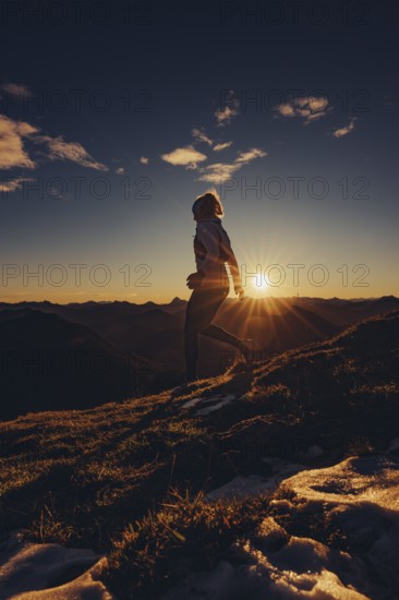 Trail running in autumn on the Jochberg on Lake Walchensee against the wonderful backdrop of the Alps, Bavaria, Germany, Europe