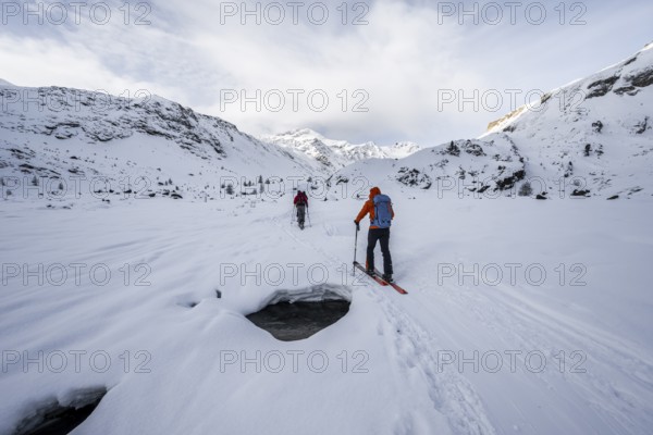 Ski tourers ascending in the rear Martell Valley, snow-covered mountain peak Monte Cevedale behind, Ortler Alps, Vinschgau Valley, Italy, Europe