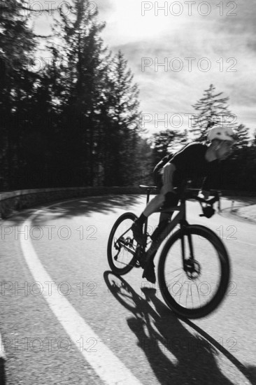 Road bike rider in spring between Lechtal and Tannheimer Tal in front of picturesque scenery of the Alps, Tyrol, Austria, Europe