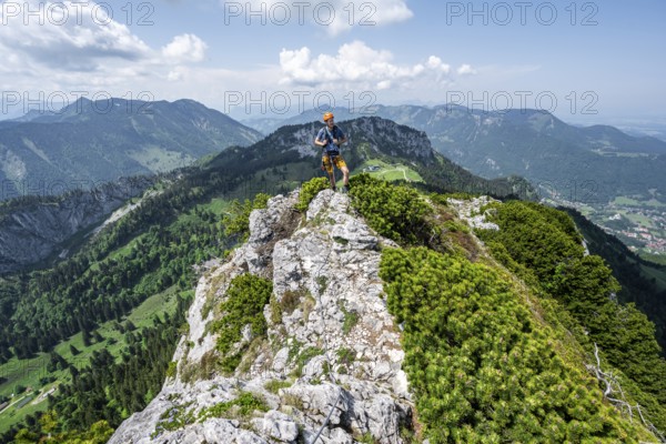 Climber on a climbing tour, climber on a mountain ridge, alpine climbing, crossing the Kampenwand, Chiemgau, Bavaria, Germany, Europe