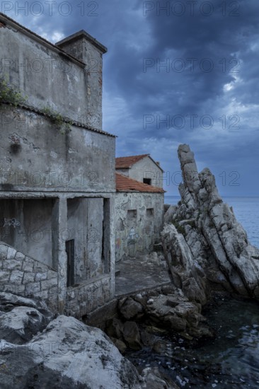 Lost Place, Abandoned building ruins by the sea under dramatic clouds, Trpanj, Peljesac, Neretva, Croatia, Europe