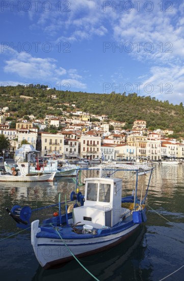 Small fishing boats in the Mediterranean harbour of Gythio or Gythion, behind houses and the Taygetos Mountains, Mani Peloponnese, Greece, Europe