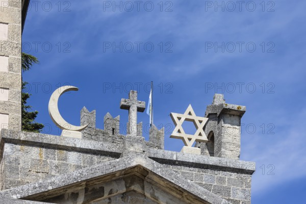 Cross of Christianity, crescent of Islam, Star of David of Judaism, Cappella Nuova historic building in San Marino. The symbols of the three monotheistic religions united