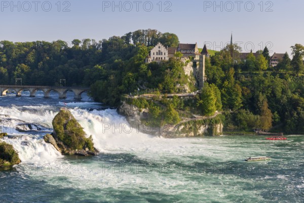 Picturesque landscape with a waterfall, river, bridge and buildings, all in a warm afternoon light, Schloss Laufen, Rhine Falls, Canton Schaffhausen, Switzerland, Europe