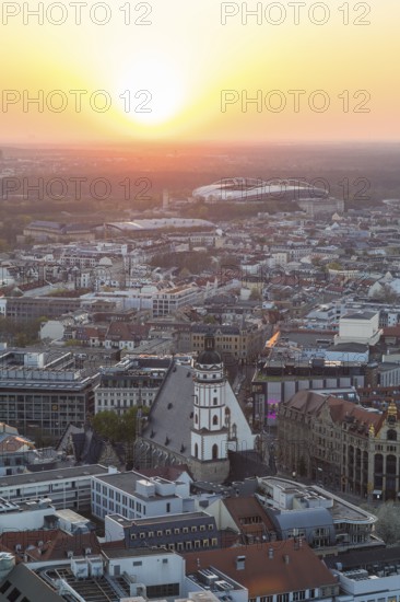 View of the city from the City Tower at sunset, St Thomas' Church, Red Bull Arena and Auwald forest, Leipzig, Saxony, Germany, Europe