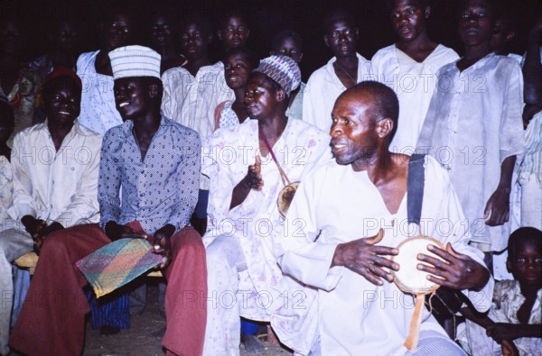 Drummers at nighttime crowd of people of the Sahel region, northern Nigeria, 1980