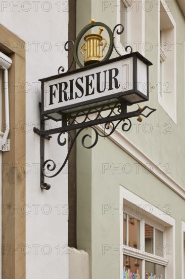 Historical sign for a hairdresser on a house in Warendorf, district of Warendorf, North Rhine-Westphalia, Germany, Europe