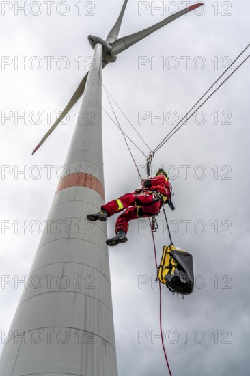 Height rescuers from the Oberhausen fire brigade practise abseiling from a wind turbine from a height of 150 metres after rescuing an accident victim from the nacelle, Issum, North Rhine-Westphalia, Germany, Europe