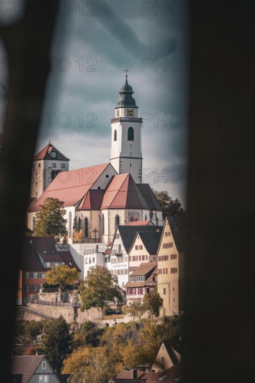 Church and historic buildings in window view, surrounded by autumn colours and blue sky, Horb, Black Forest, Germany, Europe