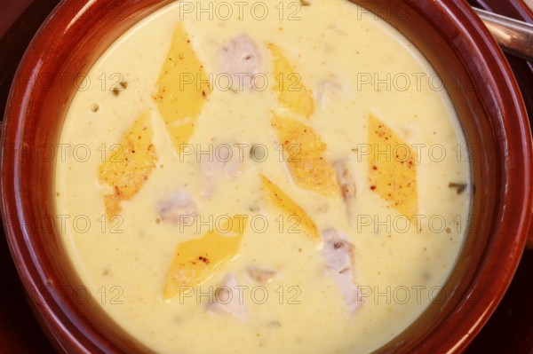 Swabian cuisine, brain soup with egg garnish, offal, calf's brain, regional, soup served in a bowl, home cooking, typical Swabian, traditional cuisine, food photography, studio, Germany, Europe