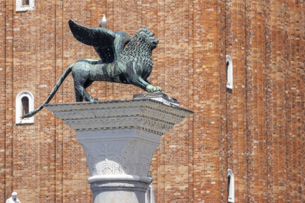 View of the city from the Canale della Giudecca, granite column on St Mark's Square with the Lion of Venice, Venice, Italy, Europe