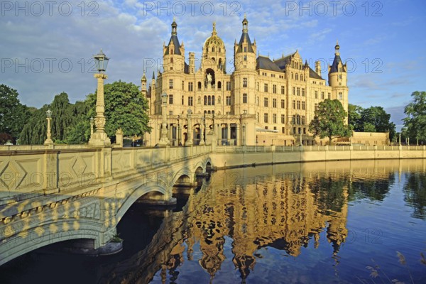 Europe, Germany, Mecklenburg-Western Pomerania, Schwerin, Schwerin Castle, built 1845 to 1857 in the style of romantic historicism, today seat of the state parliament, front with bridge to the castle island, evening light, Schwerin, Mecklenburg-Western Pomerania, Germany, Europe