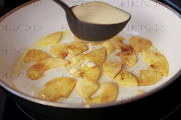 Swabian cuisine, preparation fry apple pieces, put raw dough in pan, soup ladle, pancake with apple, Flädle, cinnamon, apple crisp with lavender ice cream, dessert, dessert, dessert, typical Swabian, home cooking, traditional cuisine, food photography, studio, Germany, Europe