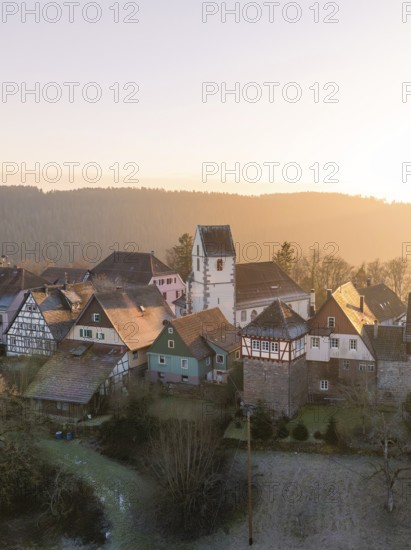 A small village with half-timbered houses and a church in the morning light, surrounded by forests, Zavelstein, district of Calw, Black Forest, Germany, Europe