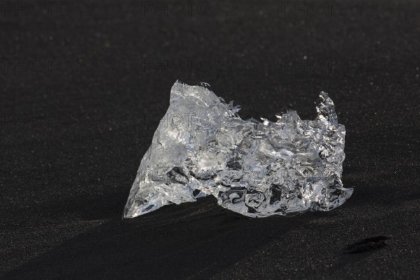 Little icebergs and crushed ice on the black beach at Joekulsarlon glacial lake