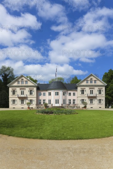 Villa Eugenia, last residence of the Princes of Hohenzollern-Hechingen, classicist central building built from 1786 to 1787 by Prince Joseph Wilhelm as a summer pleasure garden house, side wings added from 1833 to 1834, residence for the then hereditary prince and later princely couple Friedrich Wilhelm Konstantin and Eugenie, meadow, park, garden, historic building, architecture, clouds, sky, flagpole, Hohenzollern coat of arms, Hechingen, Zollernalbkreis, Baden-Württemberg, Germany, Europe