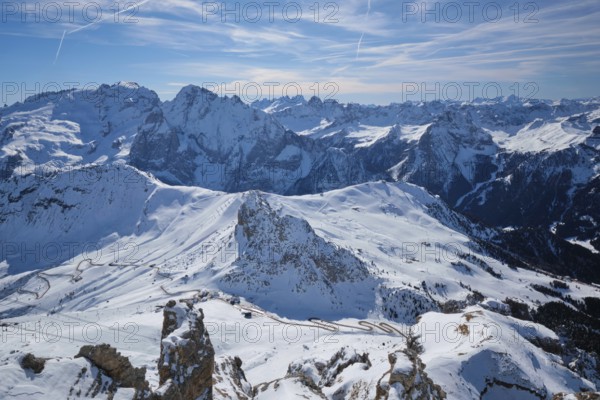 View of a ski resort piste and Dolomites mountains in Italy from Passo Pordoi pass. Arabba, Italy, Europe