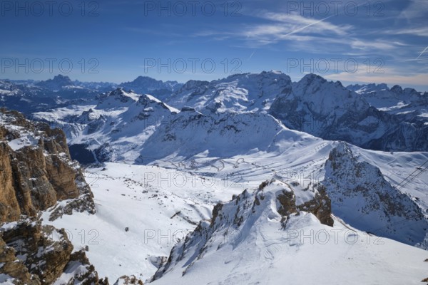 View of a ski resort piste and Dolomites mountains in Italy from Passo Pordoi pass. Arabba, Italy, Europe