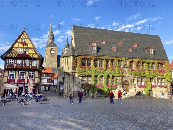 Rectht's historic town hall, on the left old half-timbered house, in the background steeple of market church St. Benediktii, in the foreground cobblestones of market square, Quedlinburg, Harz Mountains, Saxony-Anhalt, Germany, Europe