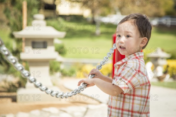 Young chinese and caucasian boy having fun at the park