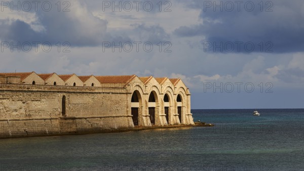 Green sea, Dark clouds, Dramatic light, Tonnara, Old tuna factory, Favignana town, Main town, Favignana, Egadi Islands, Sicily, Italy, Europe