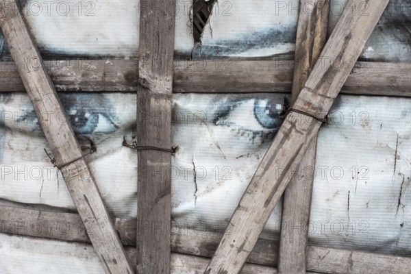 Plastic sheet with eyes, detail of an informal dwelling, Tejgaon Slum Area, Dhaka, Bangladesh, Asia