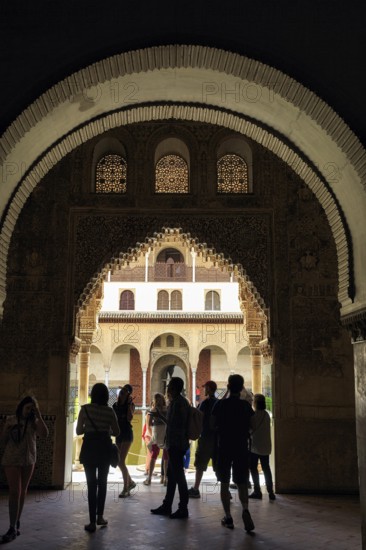 View through a gate, arabesque Moorish architecture, silhouette of tourists, Nasrid Palaces, Alhambra, Granada, Andalusia, Spain, Europe