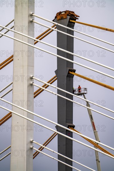 The new Rhine bridge Neuenkamp, the A40, white pillar ropes, and the old motorway bridge, which is being dismantled, preparation for demolition, workers on cherry pickers measure, mark the old bridge pillar, Duisburg, North Rhine-Westphalia, Germany, Europe