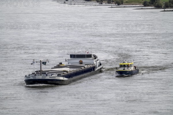 Water police boat sailing alongside a cargo ship on the Rhine near Duisburg, WSP 12, a police officer on board the freighter routinely checks the ship's papers, North Rhine-Westphalia, Germany, Europe