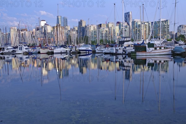 Boats in the harbour with glass facades of skyscrapers reflected in the water, Stanley Park, Vancouver Downtown, British Columbia, Canada, North America