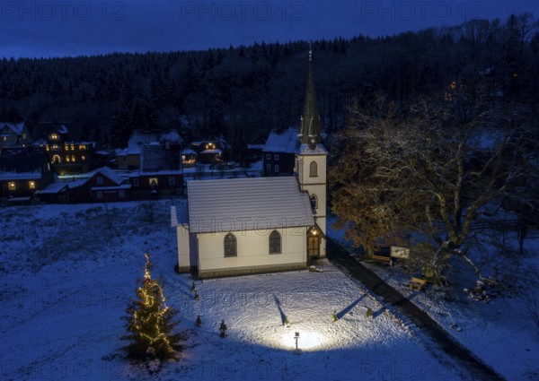 A Christmas tree stands in front of the smallest wooden church in Germany, Elend, 29 December 2020