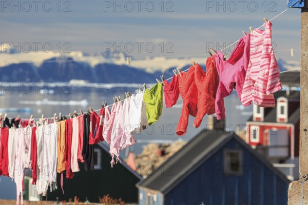 Colourful laundry drying on a washing line in an Inuit settlement, Ittoqqortoormiit, Scoresby Sund, East Greenland, Greenland, North America