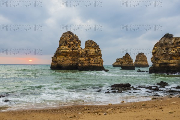 Rocky coast with beach and red rocks, Praia do Camilo, Lagos, Algarve, Portugal, Europe