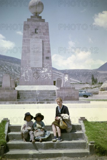 Tourist with local children at the equator monument from 1936, Ciudad Mitad del Mundo, Pichincha, Ecuador, South America 1962, South America