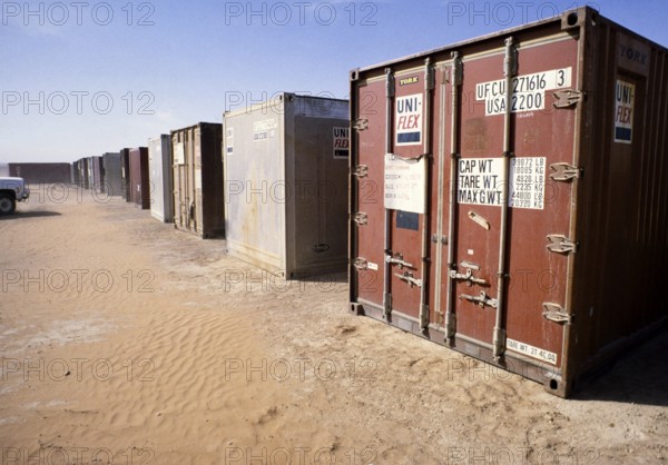 Shipping container with equipment in a storage facility for oil drilling, Dhahran, Arabian Desert, Saudi Arabia 19789